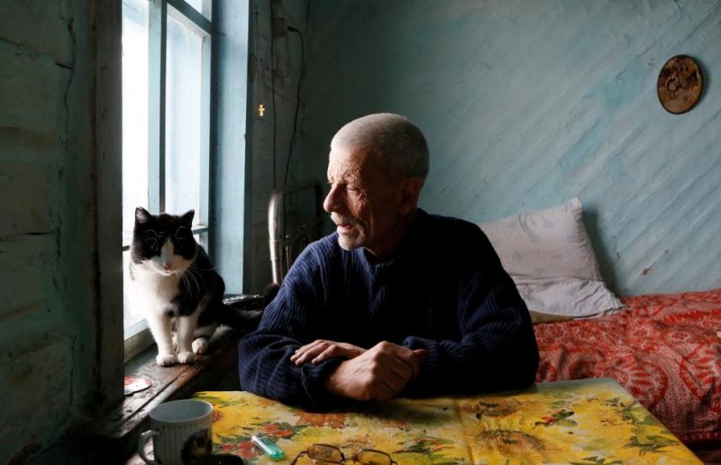 Baburin talks to his cat Marquis at his house in remote Siberian village of Mikhailovka