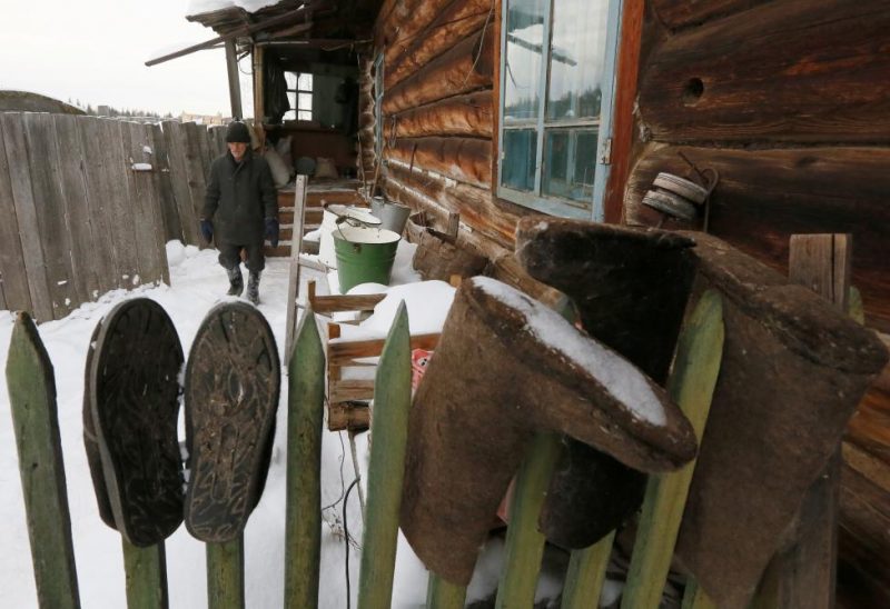 Baburin walks at court yard of his house in remote Siberian village of Mikhailovka